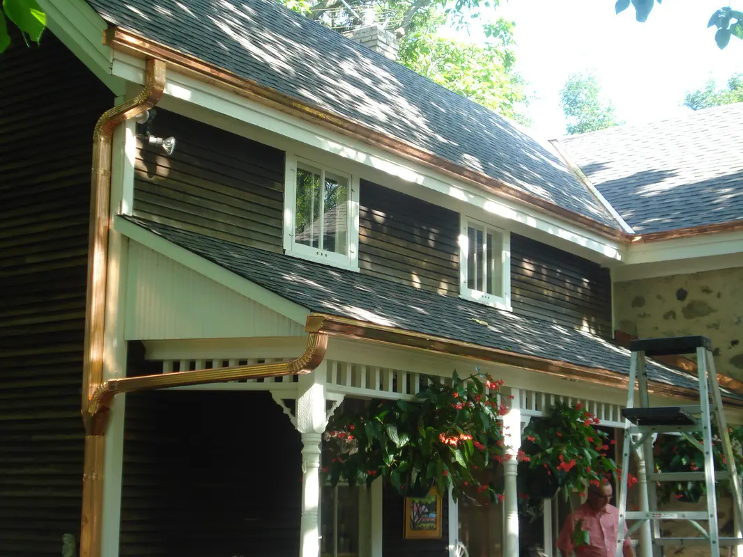 A house with two windows and a porch.